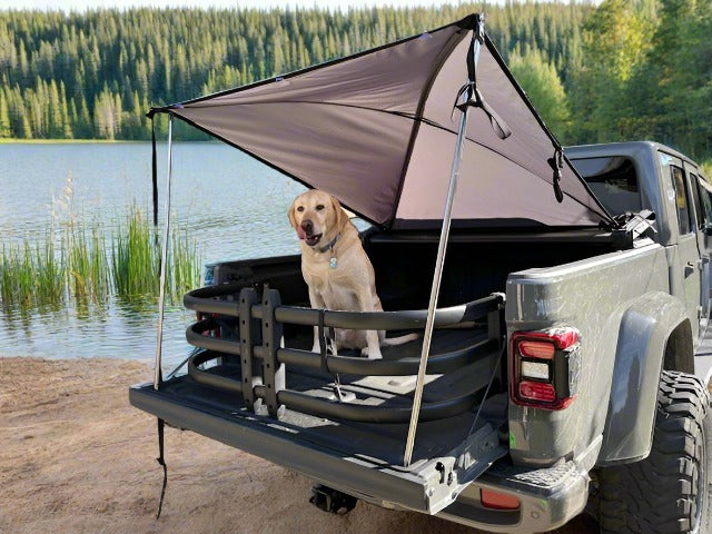 Dog sitting under sport  trail topper in JT Jeep truck