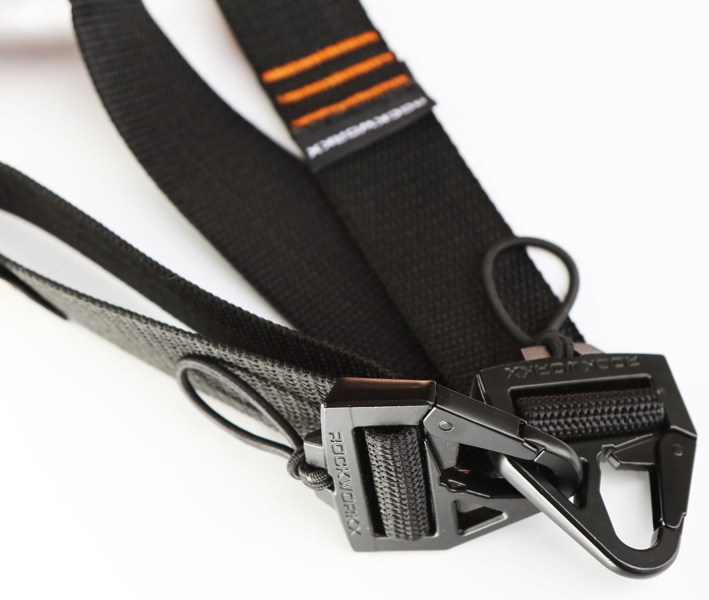 Close-up of a black and orange trim tie-down strap with a metal carabiner clip on a white background