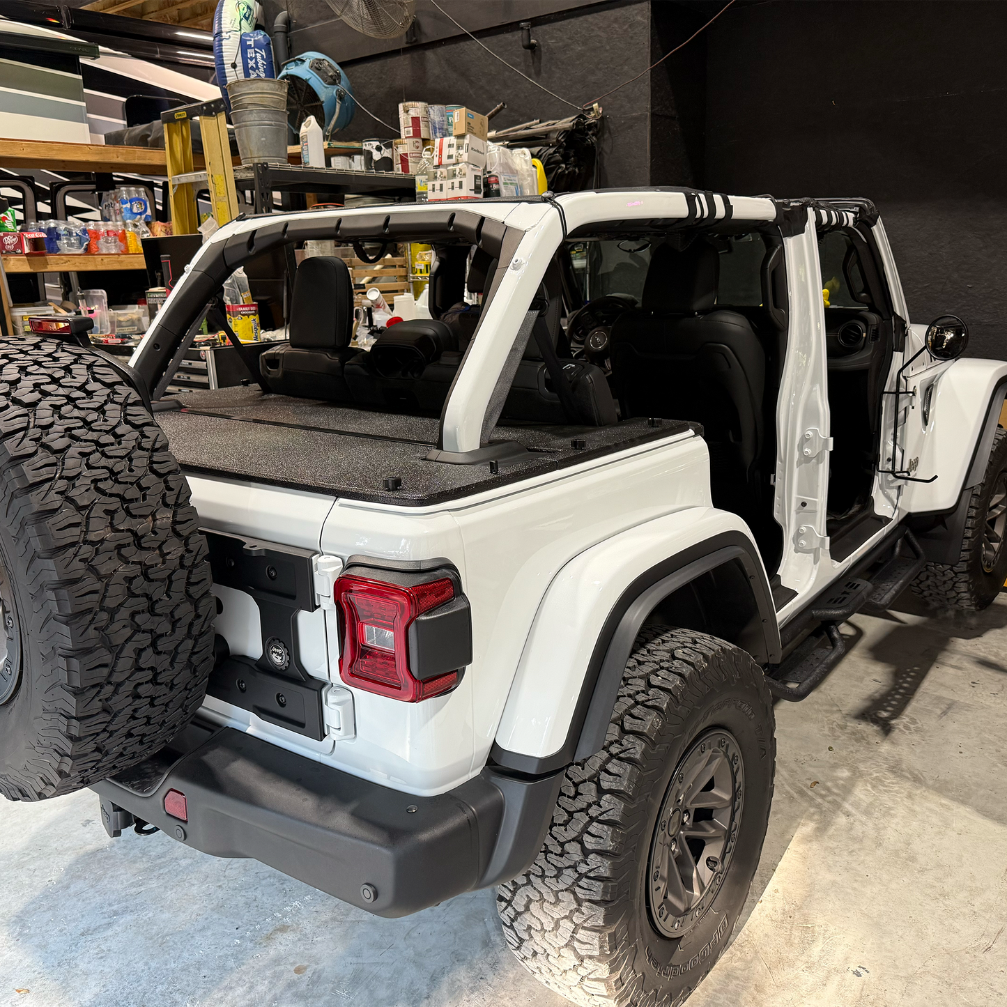 24/25 JLU rhino-lined cargo cover on white Jeep Rubicon 392 in garage