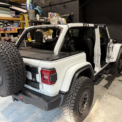 24/25 JLU rhino-lined cargo cover on white Jeep Rubicon 392 in garage