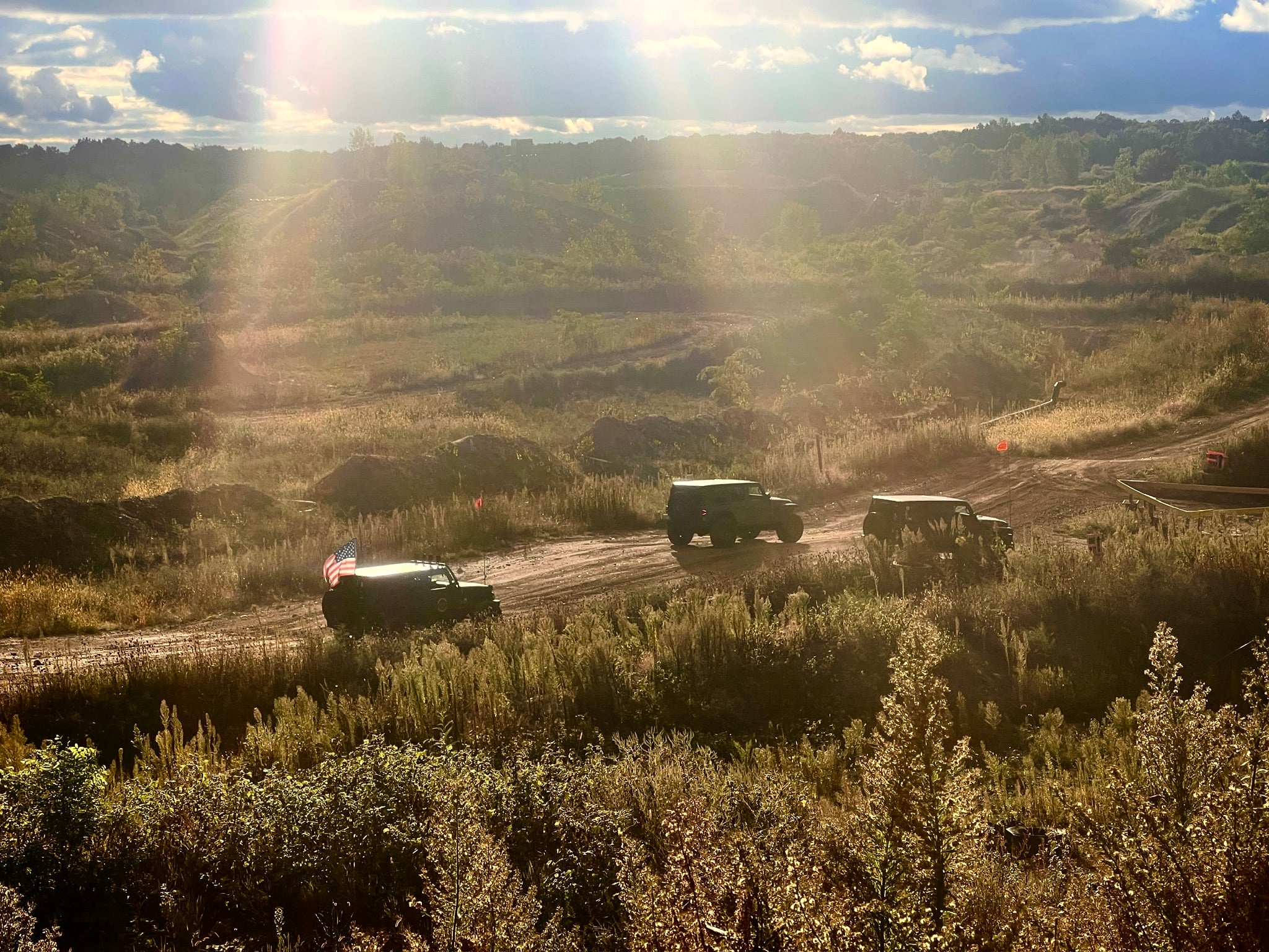 3 Jeeps driving in a quarry at sunset 2024 Detroit 4 Fest in Holly, Michigan