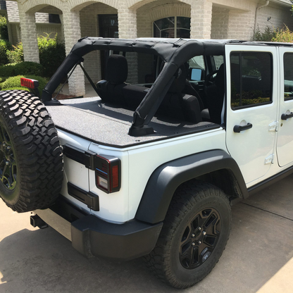 White Jeep Wrangler JKU with black sun screen and rhino lined cargo cover with tire on trunk