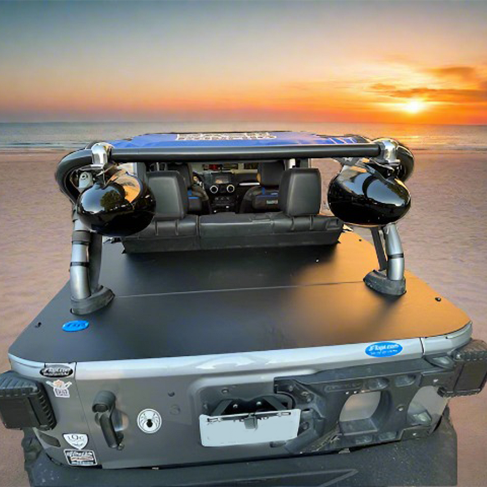 JKU Wrangler on the beach with low profile aluminum cargo cover over trunk space and no top