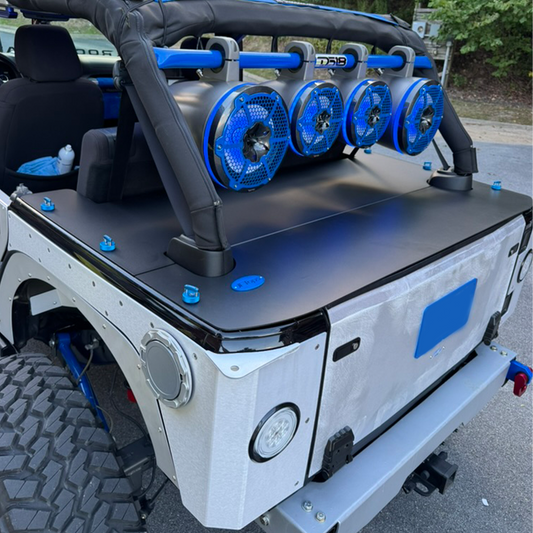 Sound system with blue speakers on Wrangler JKU Hard Top Aluminum low profile cargo cover on open trunk space