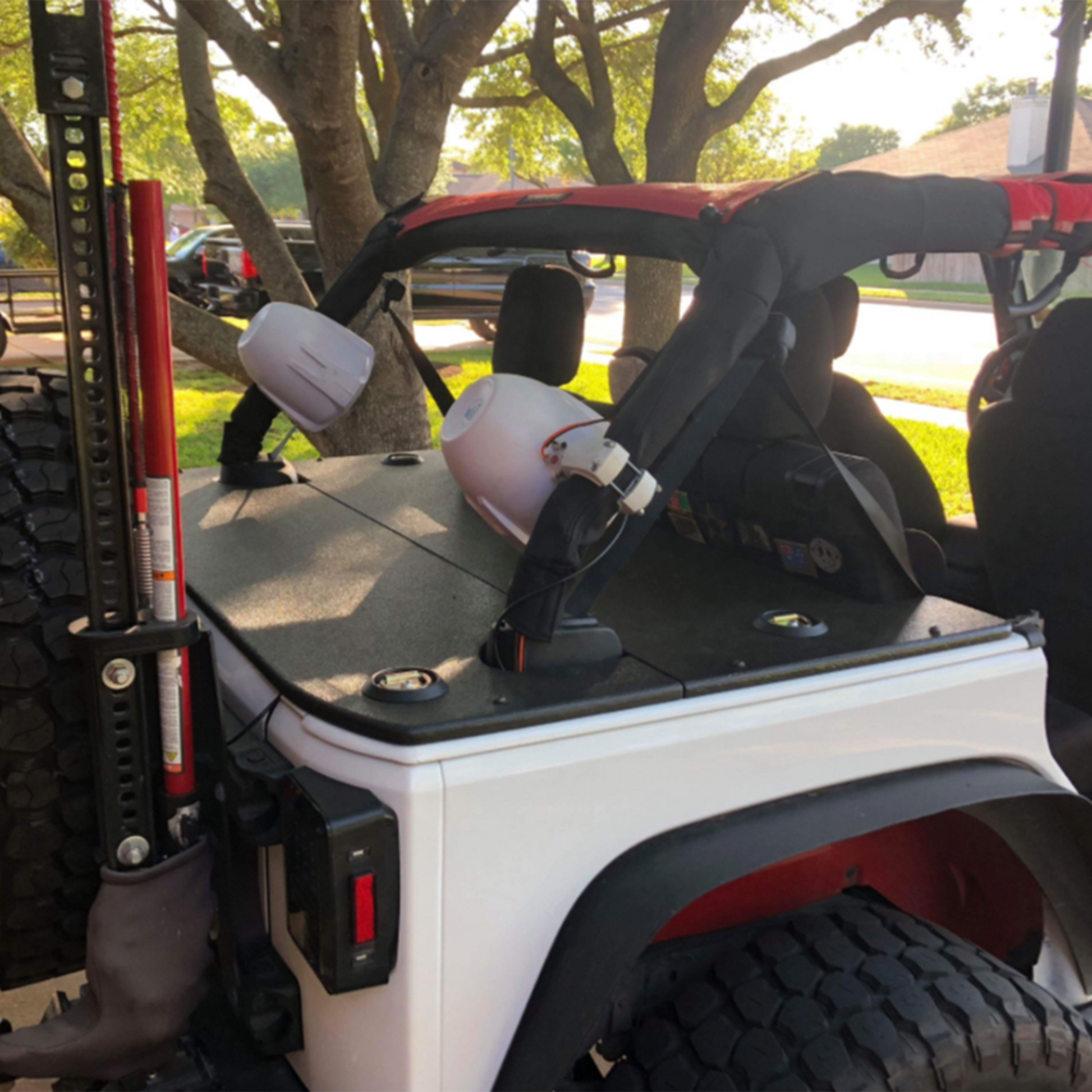 White JKU Jeep with speakers and rhino lined jftops cargo cover on trunk