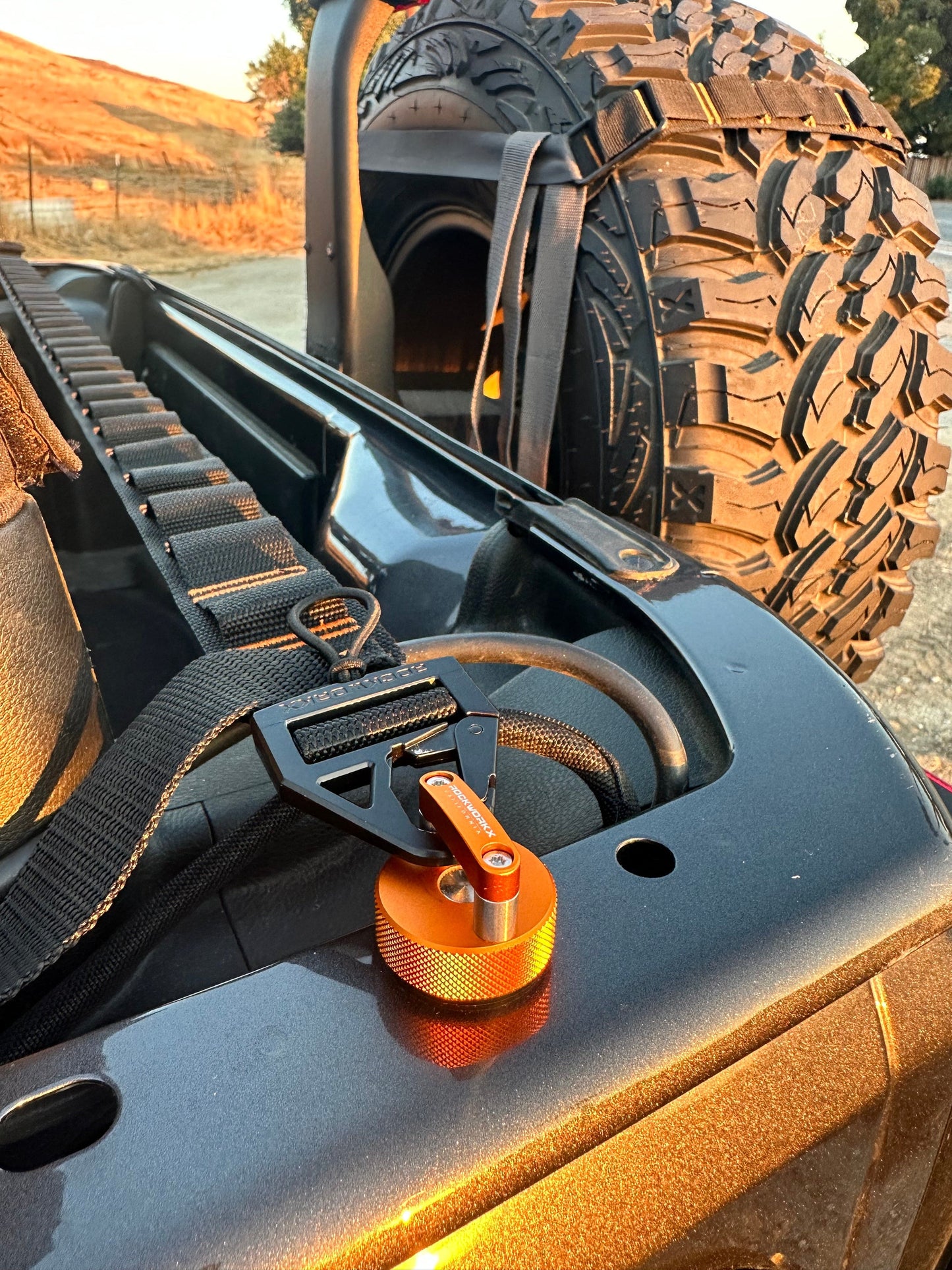 Rockworkx 2 in tie-down strap with 1.5 in molle connector Orange thread