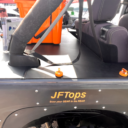 JFTops JKU Wrangler Jeep cargo cover with an orange cooler in the background and Rockworkx orange hard top thumbscrews